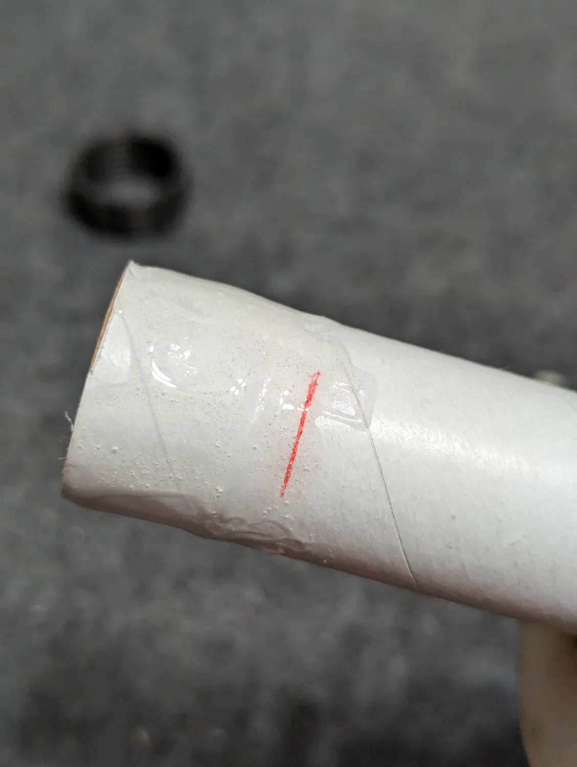 Epoxy spread between the aft end and the mark.