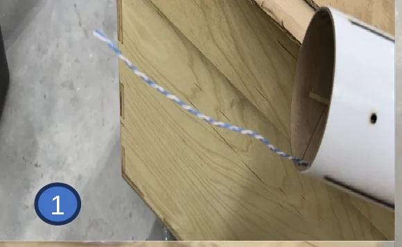 1 — Wire threaded in through the rail button hole and back out the aft end of the tube.