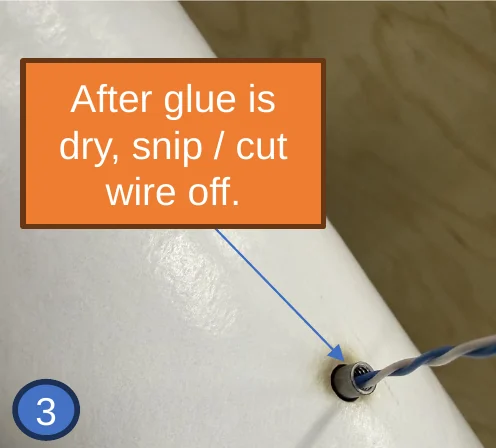 3 — Nut pulled up into the hole, wire still protruding. Hold 60 seconds, then snip the wire flush at the nut.