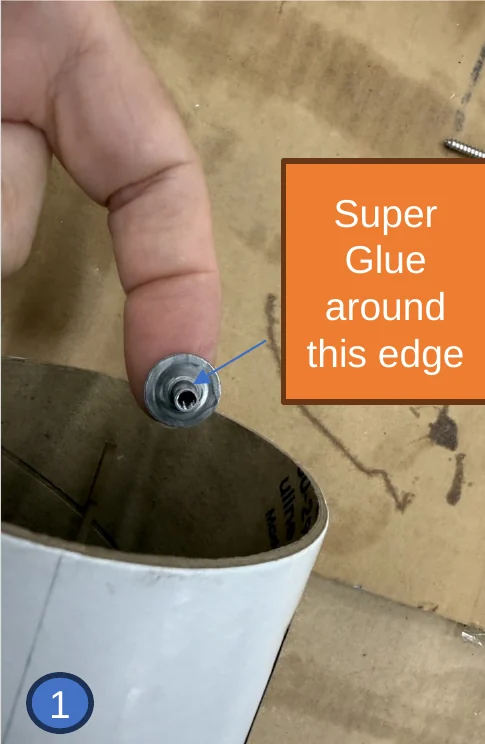 1 — Weld nut balanced on a fingertip. The arrow shows the inner edge that gets the superglue.