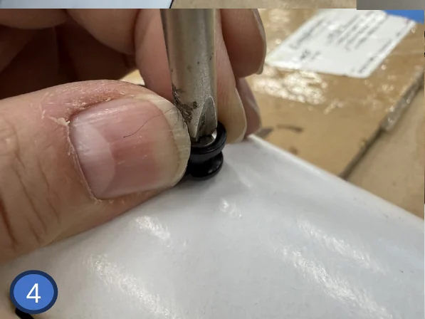 4 — Start the screw by hand, pulling the button outward as you tighten.