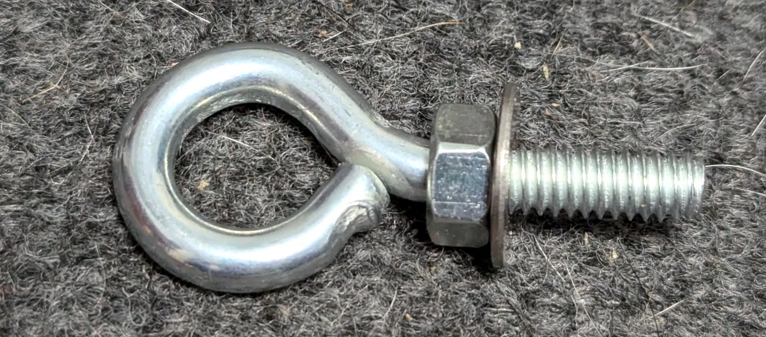 ¼-20 eyebolt with nut and washer.