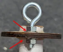 Epoxy over the eyebolt nut and washer so they cannot loosen.