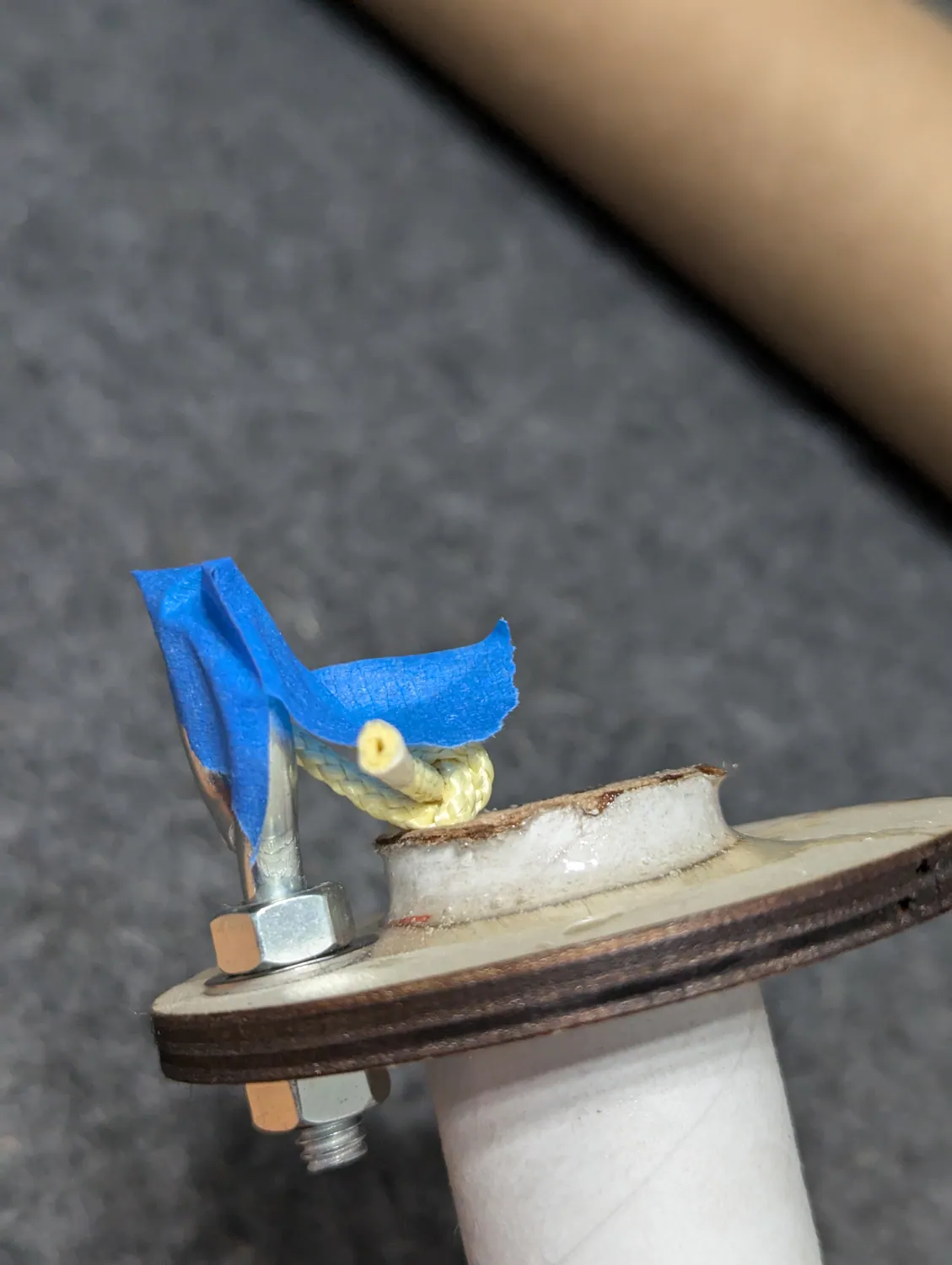 Blue tape over the cord and eyebolt.