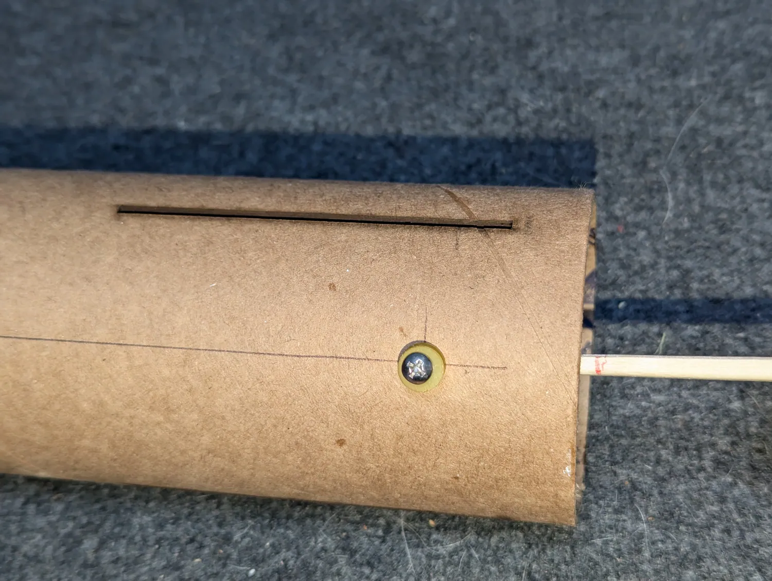 Reaching in with the marked stick to lay the internal glue ring.